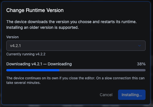 The same dialog mid-install. The Version field shows v4.2.1 with "Currently running v4.2.2" beneath it, a progress bar reads "Downloading v4.2.1 — Downloading" at 38%, and a note says the device continues on its own if you close the editor and that on a slow connection this can take several minutes. The buttons read Cancel and Installing…